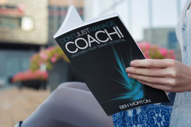 woman reading don't just manage, coach book by ben morton